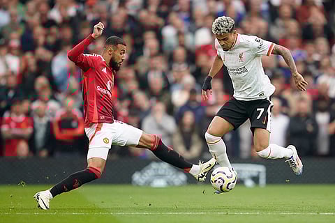English Premier League 2024-25 Liverpool vs Manchester United: Manchester United's Noussair Mazraoui, left, challenges for the ball with Liverpool's Luis Diaz